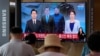 A TV shows a file image of North Korean leader Kim Jong Un, third from left, and South Korean President Moon Jae-in, second from left, during a news program at the Seoul Railway Station in Seoul, South Korea, July 27, 2021.