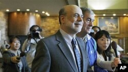 Federal Reserve chairman Ben Bernanke walks past reporters without speaking as he arrives at a morning session of the Economic Policy Symposium at Jackson Hole in Moran, Wyoming, August 26, 2011