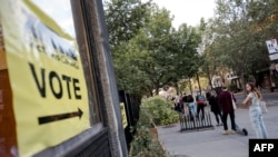 People wait in line to cast their ballots at Ecole Laurier on voting day for the 2021 Canadian election in Montreal, Quebec on Sept. 20, 2021.