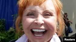 FILE - Former "Mickey Mouse Club" Mouseketeer Doreen Tracey poses near Stage One on The Walt Disney Studios lot after its rededication as the "Annette Funicello Stage" in honor of the late Mouseketeer in Burbank, Calif., June 24, 2013. Stage One was the home of the original "Mickey Mouse Club" TV series.