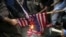 Iranian demonstrators burn representations of the U.S. flag during a protest in front of the former U.S. Embassy in response to President Donald Trump's decision to pull out of the nuclear deal and renew sanctions, in Tehran, Iran, May 9, 2018. 