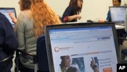 Public health office staff members in Champaign, Illinois, work with people trying to sign up for health care coverage through the Affordable Care Act, also known as Obamacare, October 1, 2013.