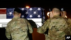 FILE - A U.S. Army carry team loads a transfer case containing the remains of Capt. Andrew P. Ross into a vehicle, Nov. 30, 2018, at Dover Air Force Base, Del.