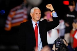 Vice President Mike Pence makes a fist at the end of a rally in Kinston, North Carolina, Oct. 25, 2020.