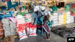FILE: Two elderly women shop for mealie meal and other basic commodities, March 14 2019, in the Mutoko rural area of Zimbabwe. Eastern Zimbabwe receives help to fight drought induced hunger. 