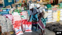 FILE: Two elderly women shop for mealie meal and other basic commodities, March 14 2019, in the Mutoko rural area of Zimbabwe. Eastern Zimbabwe receives help to fight drought induced hunger. 