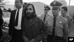 Charles M. Manson, leader of a hippie cult accused of multiple murders, leaves a Los Angeles courtroom, Dec. 22, 1969 after telling a judge "lies have been told" about him.