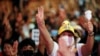 Pro-democracy activists show the three-finger salute as they protest after the constitutional court's ruling on Prime Minister Prayuth Chan-Ocha's conflict of interest case, in Bangkok, Thailand, Dec. 2, 2020. 