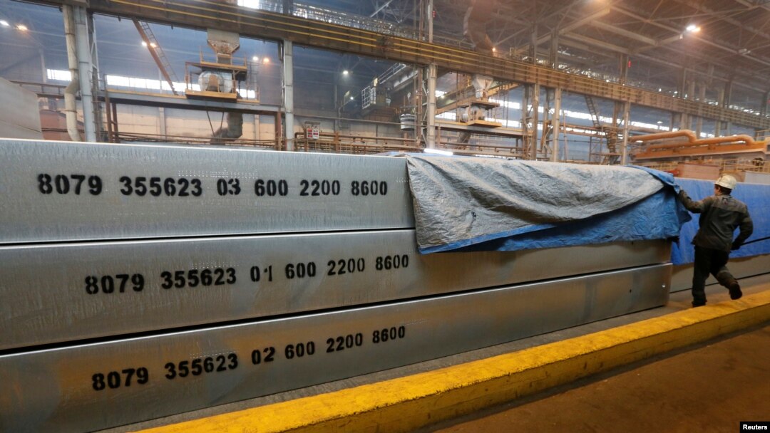 FILE - An employee removes a covering of 13-meter aluminium ingots at the foundry shop of the Rusal Krasnoyarsk aluminium smelter in Krasnoyarsk, Russia, July 27, 2016. Rusal is among Russian companies on a new U.S. sanctions list.