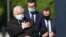 Poland's ruling party leader Kaczynski, left, and PM Morawiecki, center, pray at the monument to the late President Lech Kaczynski, the party leader's twin, killed with 95 others in a plane crash April 10, 2010 in Russia, in Warsaw, May 10, 2020.