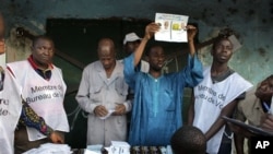 Guinean election officials count votes after the closing of the polls at an outdoor polling station in Conakry, Guinea, November 7, 2010.