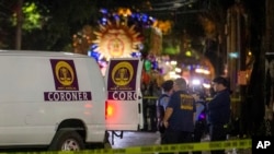 Emergency personnel work at the scene after a person was run over and killed by a float during The Mystic Krewe of Nyx Mardi Gras parade in New Orleans, Feb. 19, 2020. 