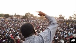 Ugandan opposition leader Kizza Besigye makes a speech during a protest rally against the rising cost of living and commodities in the Namungoona suburb of Kampala, January 24, 2012.
