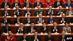 Delegates applaud during the opening ceremony of the Chinese People's Political Consultative Conference at the Great Hall of the People in Beijing on March 4, 2025. 