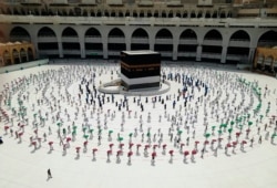 FILE - Hundreds of Muslim pilgrims circle the Kaaba at the Grand Mosque, ahead of the Hajj pilgrimage in the Muslim holy city of Mecca, Saudi Arabia, July 29, 2020.