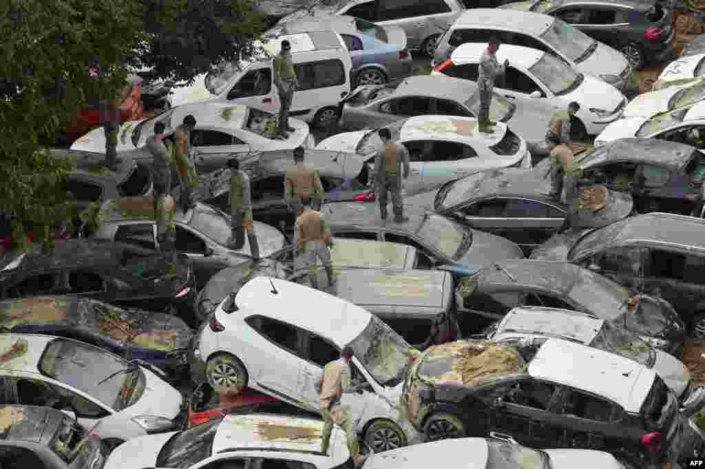 Soldiers search wrecked cars damaged by flooding in Massassana, region of Valencia, eastern Spain, on Nov. 8, 2024, in the aftermath of deadly floods.