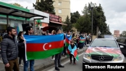 People celebrate on the streets after Azerbaijan's President Aliyev said the country's forces had taken Shusha (Shushi) during the fighting over the breakaway region of Nagorno-Karabakh, in Baku, Nov. 8, 2020.