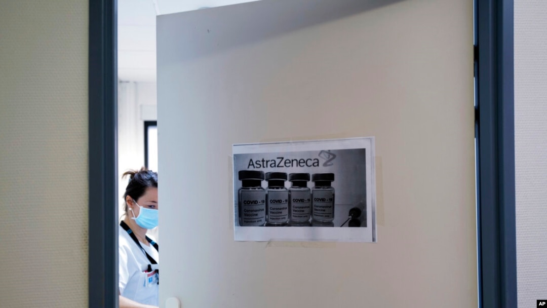 FILE - A health worker closes a door as she prepares doses of the AstraZeneca vaccine at the Edouard Herriot hospital in Lyon, central France, Feb. 6, 2021.
