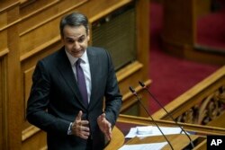 Greece's Prime Minister Kyriakos Mitsotakis, delivers a speech during a parliament session in Athens, Dec. 18, 2019.