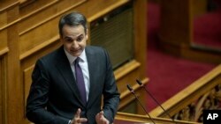 Greece's Prime Minister Kyriakos Mitsotakis, delivers a speech during a parliament session in Athens, Dec. 18, 2019. 