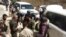 FILE - U.N. arms experts and opposition fighters are seen in Damascus' eastern Ghouta suburb on Aug. 29, 2013.