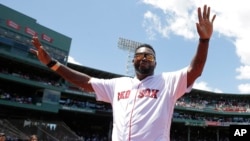 Former Boston Red Sox star David Ortiz waves to the crowd during ceremonies to honor the Red Sox 2007 World Series winning baseball team, July 30, 2017, in Boston.