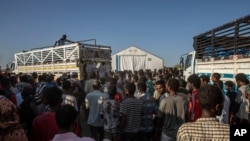 Tigray refugees who fled the conflict in Ethiopia's Tigray region, wait to receive aid at Umm Rakouba refugee camp in Qadarif, eastern Sudan, Nov. 24, 2020.