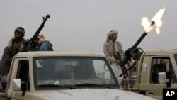 FILE - A Houthi rebel fighter fires in the air during a gathering aimed at mobilizing more fighters for the Houthi movement, in Sanaa, Yemen, Aug. 1, 2019. 