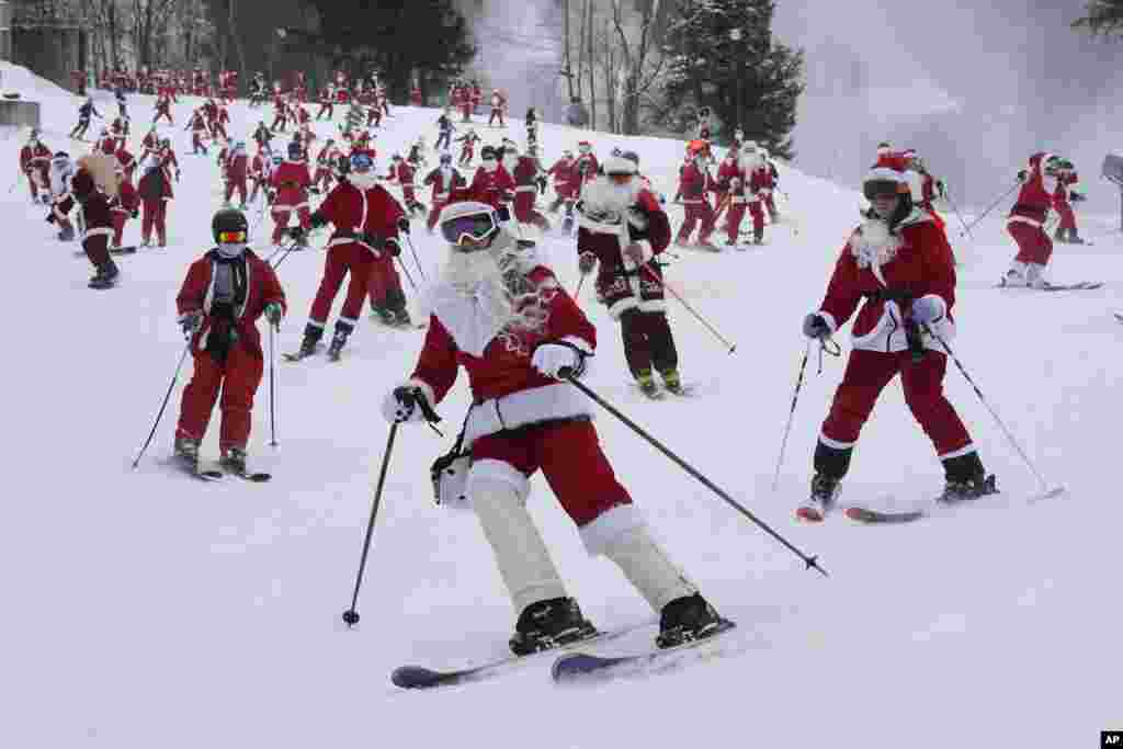 Skiers dressed in Santa Claus outfits hit the slopes for charity at the Sunday River Ski Resort, Dec. 11, 2022, in Newry, Maine.