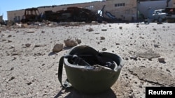 A helmet belonging to an Islamic State militant is seen on the ground at the 121 Regiment base after Fighters from the Democratic Forces of Syria took control of the base in the town of al-Melabiyyah, south of Hasaka city, Syria, Nov. 24, 2015.