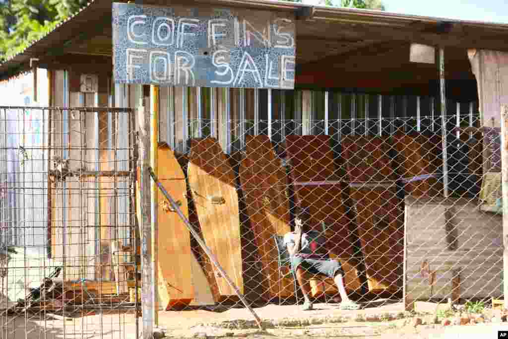 A worker at a coffin manufacturing company waits for clients in Harare, as Zimbabwe begins a 30-day lockdown in a bid to rein in the spike in COVID -19 infections threatening to overwhelm health services.