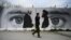 Un mur peint montrant Zalmay Khalilzad (g) le représentant spécial des États-Unis pour la réconciliation en Afghanistan et le cofondateur des talibans, Mullah Abdul Ghani Baradar, à Kaboul, le 5 avril 2020.
