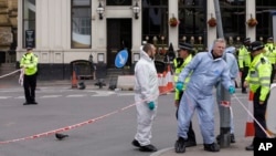 Forensic police investigate in the London Bridge area of London, June 5, 2017. 