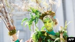 Une femme déguisée en arbre avec le groupe The Forgotten Solution, pose pour une photo à Civic Center Plaza après avoir participé à l’action mondiale «Rise For Climate» le 8 septembre 2018 au centre-ville de San Francisco, en Californie.