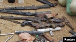 Confiscated weapons are displayed after a military raid on a hideout of suspected Islamist Boko Haram members in Nigeria's northern city of Kano, August 11, 2012.