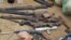 Confiscated weapons are displayed after a military raid on a hideout of suspected Islamist Boko Haram members in Nigeria's northern city of Kano, August 11, 2012.