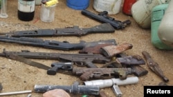 Confiscated weapons are displayed after a military raid on a hideout of suspected Islamist Boko Haram members in Nigeria's northern city of Kano, August 11, 2012.