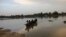 Residents navigate a boat across floodwater after heavy rains in Ndjamena, Chad September 2, 2022. Thousands battle floods after Chad's heaviest rains in over 30 years.