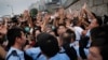 Student protesters resist during change of shift for local police but backed down after being reassured they could reoccupy the pavement outside the government compound’s gate in Hong Kong, Oct. 2, 2014.