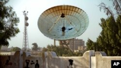 A satellite dish stands damaged after an attack on Egypt's main satellite station in the Maadi district of Cairo October 7, 2013.