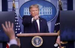FILE - President Donald Trump points to a reporter for a question during a news briefing at the White House in Washington, July 21, 2020.