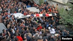 Relatives, friends and other mourners attend the funeral of Shaimaa al-Sabbagh, an activist at the Socialist Popular Alliance Party, during her funeral in Alexandria, Egypt, January 25, 2015.