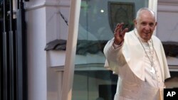 Pope Francis waves to the crowd as he arrives at the Nunciature in Bogota, Colombia, Sept. 6, 2017, beginning a five-day visit in the country. 