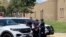 In this image from taken from video courtesy of Ryan Laughlin/KOB 4 TV, Albuquerque, NM, police search a student after a shooting at Washington Middle School which left one student dead and another in custody, police said Friday, Aug. 13, 2021.