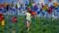A girl spins pinwheels at a peace park, which was built to deliver the peace between North and South Korea, near the border village of Panmunjom in Paju, north of Seoul, South Korea.