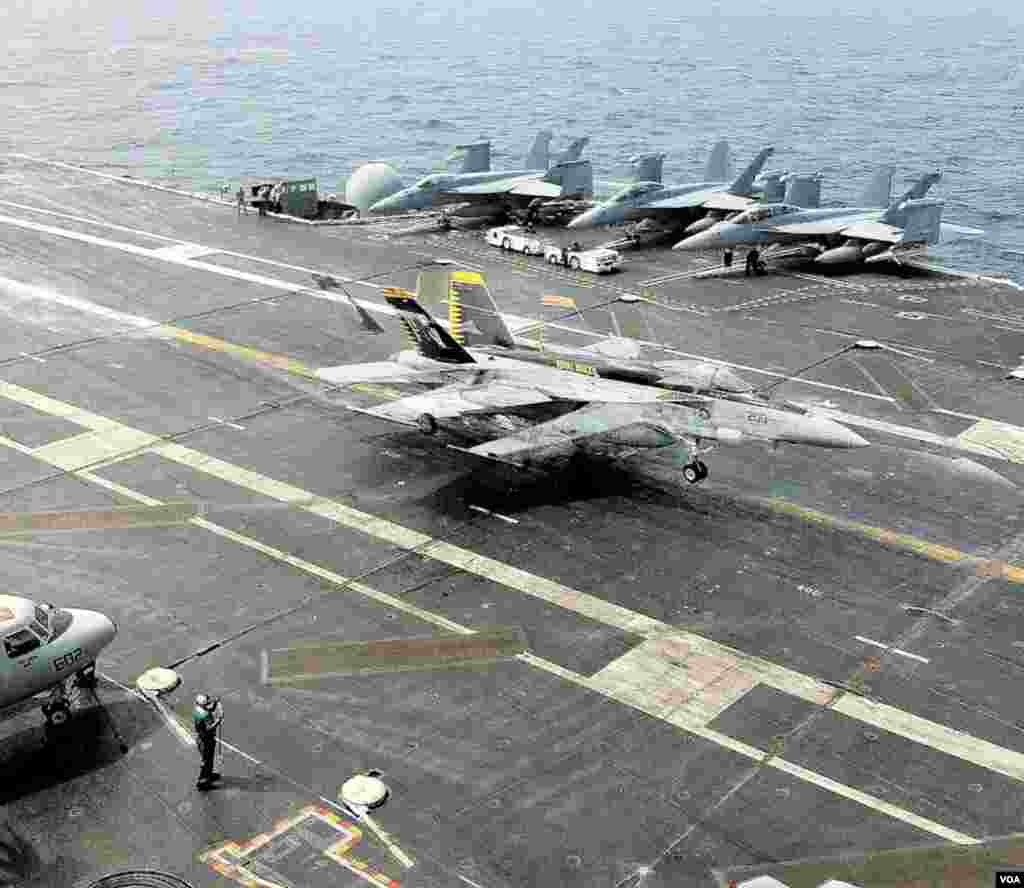An F-18 fighter jet's tailhook is grabbed by an arresting wire on the flight deck of the USS George Washington in the Yellow Sea, June 24, 2012. (VOA/S. Herman)