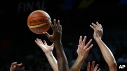 FILE - United States' and Serbia's players go for the ball during the final World Basketball match at the Palacio de los Deportes stadium in Madrid, Spain, Sept. 14, 2014. The women's basketball World Cup will be held Sept. 22-30, 2018, in Spain.
