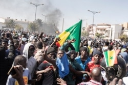 Protesters gather at Place of the Nation during a protest in Dakar on March 8, 2021, after the country's opposition leader Ousmane Sonko was charged with rape.