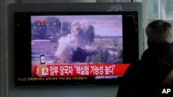 FILE - A South Korean man watches TV news showing file footage of a North Korean nuclear test at the Seoul train station in Seoul, South Korea, Feb. 12, 2013. 