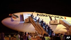 FILE - Passengers exit an Air France plane after it landed at Tehran's Imam Khomeini International Airport, south of the capital Tehran, Iran.